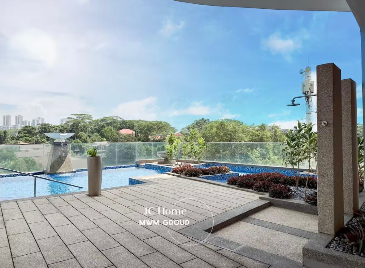 Pool deck with greenery and open sky
