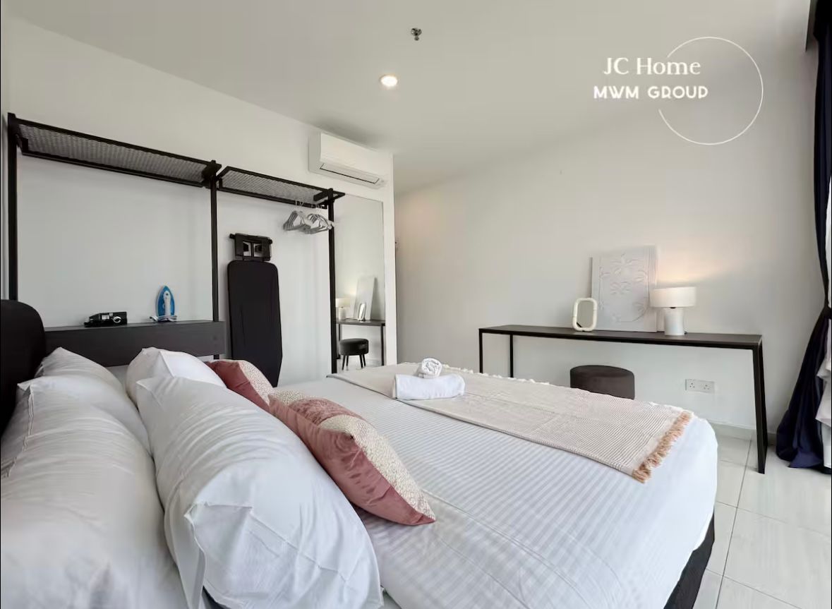 Bedroom with writing desk and open wardrobe