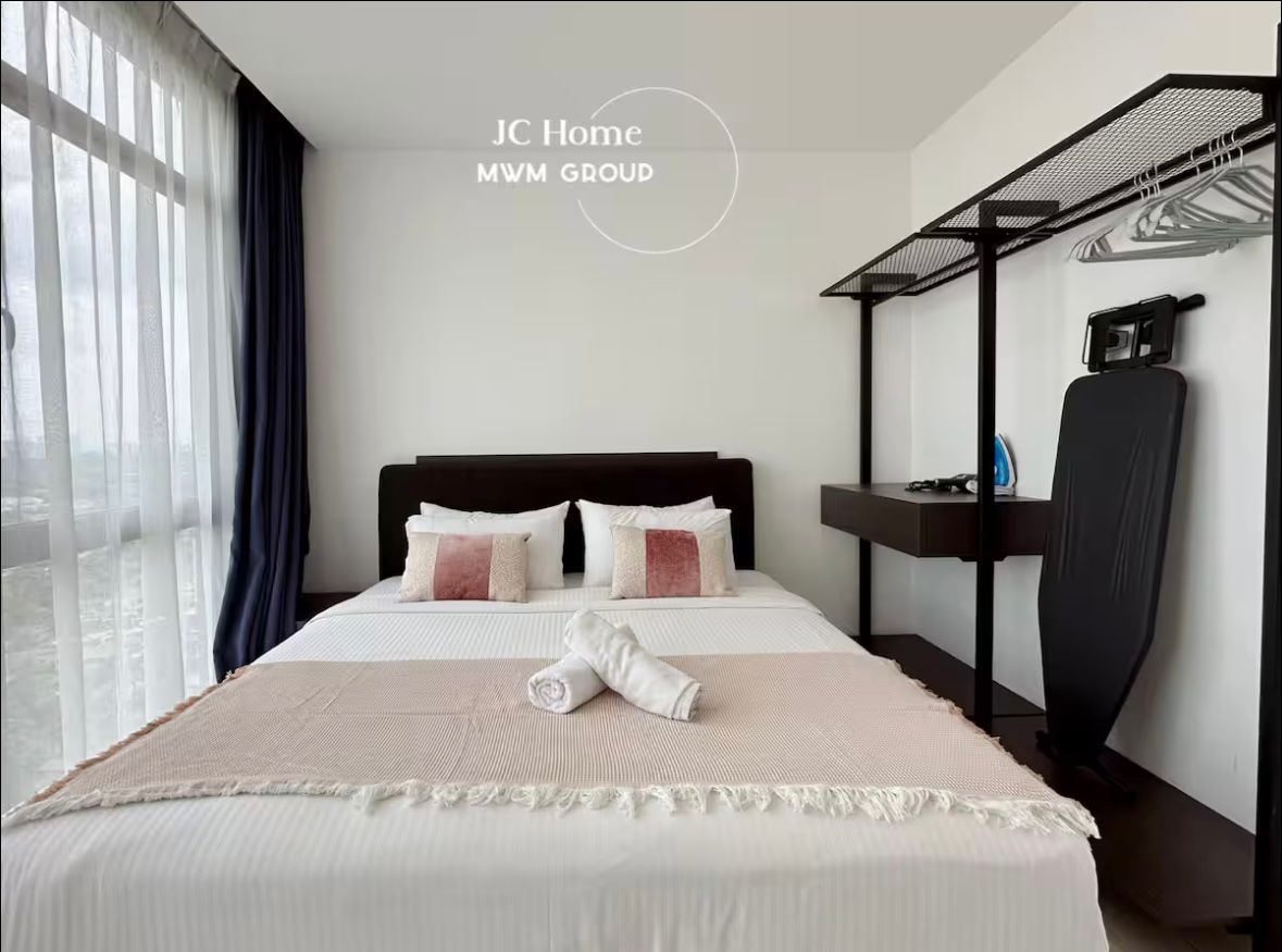 Bedroom with wardrobe and ironing amenities